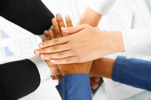 Leader and his employees hands in unity